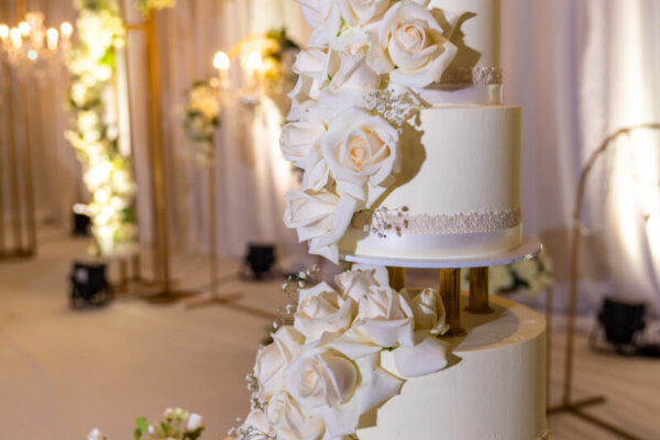 Beautiful white wedding cake decorated with white roses